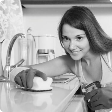 photo of a female cleaner cleaning around a sink