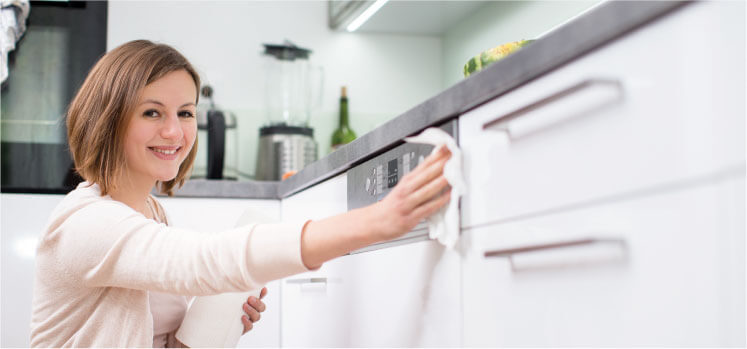 image of a cleaner cleaning an oven