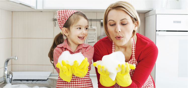 photo of a female cleaner and her daughter holding clouds of foam in their hands