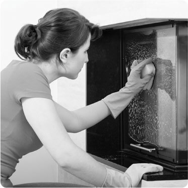 photo of a female cleaner cleaning s glass book shelf