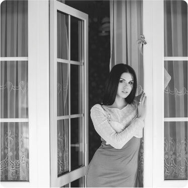 photo of a lovely lady leaning on the door of her freshly cleaned porch